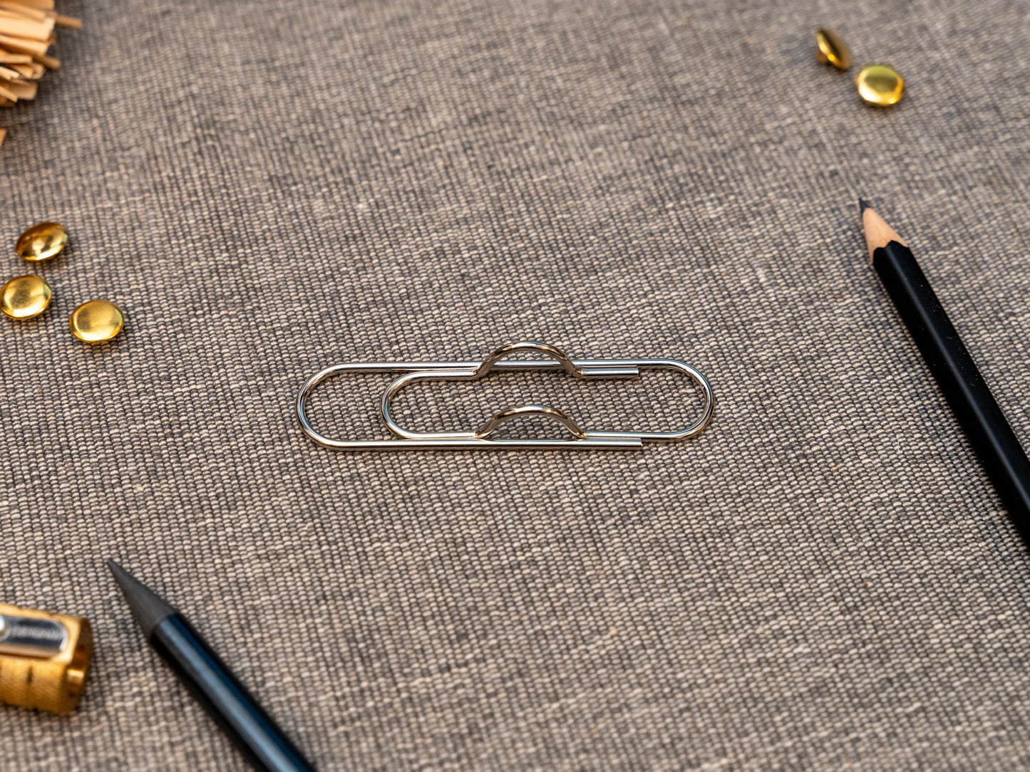 Silver notebook pen clip in that looks like a paperclip