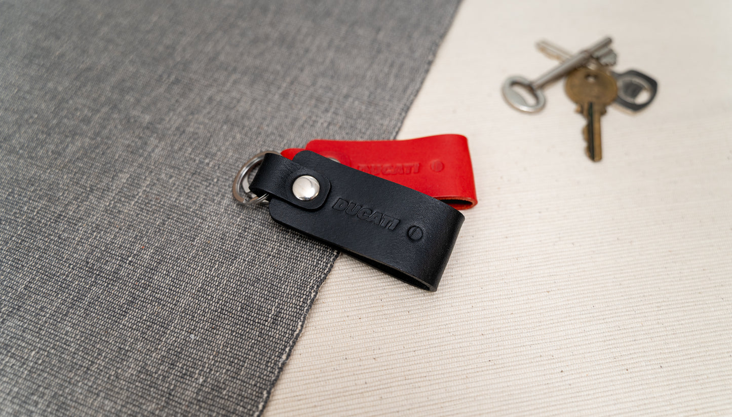 Two Ducati text logo leather keychains in black and red leather with stainless steel hardwarehardware