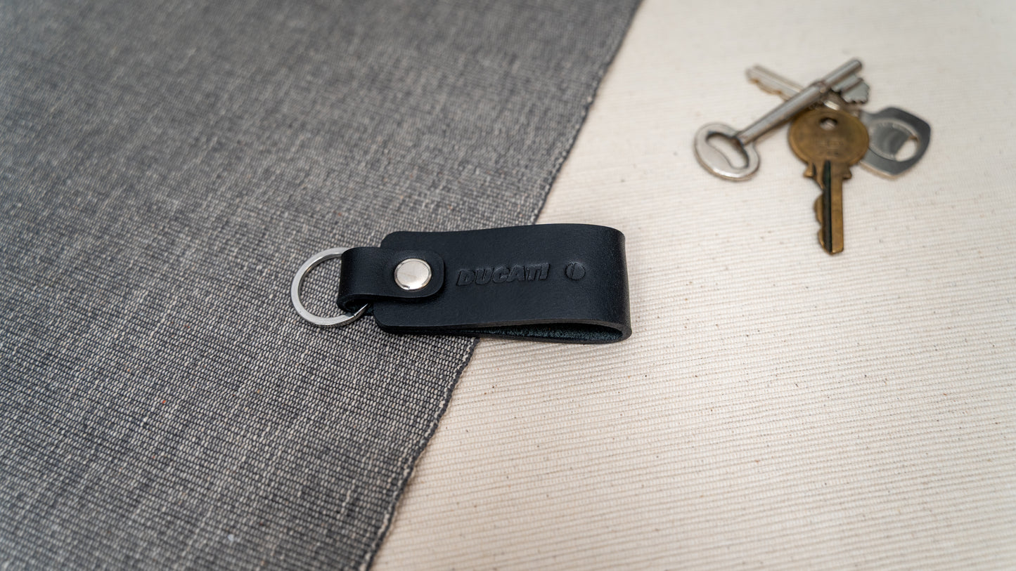 Ducati text logo red keychain in black leather with stainless steel hardware