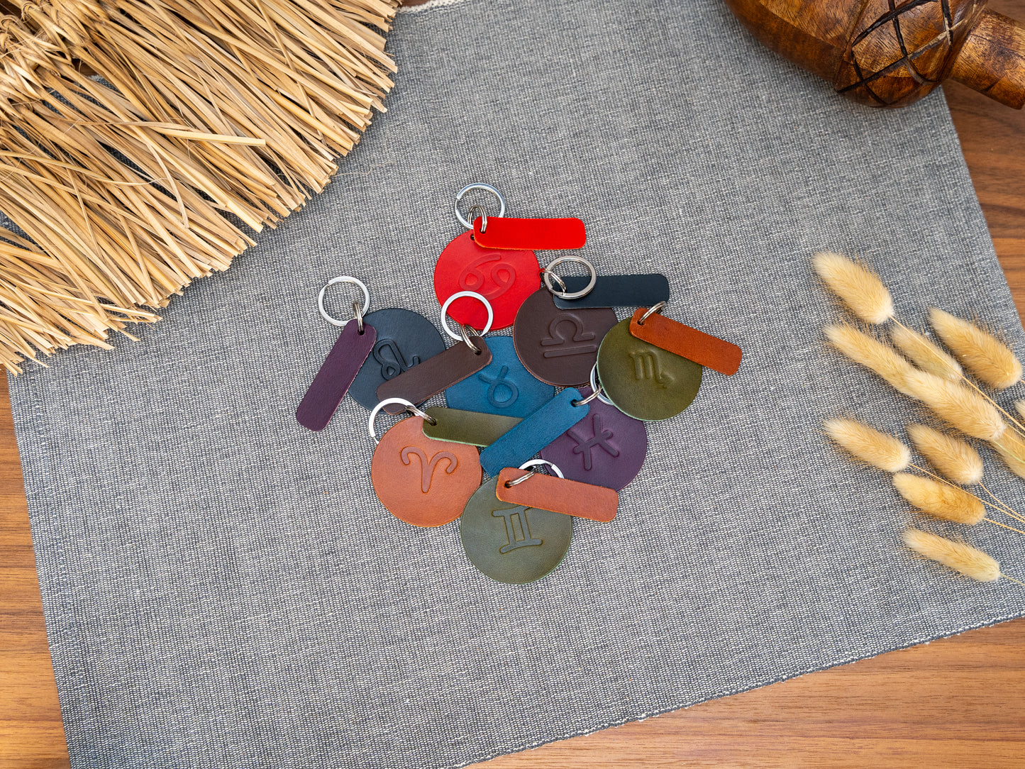 Mixture of round keyrings debossed with various zodiac signs. Keyrings also have a rectangular tab that can be personalised in black, tan, olive green, purple, red, navy blue and dark brown. Can be stamped with custom logos such as car logos, company logos. Available in several colours with stainless steel or brass hardware.