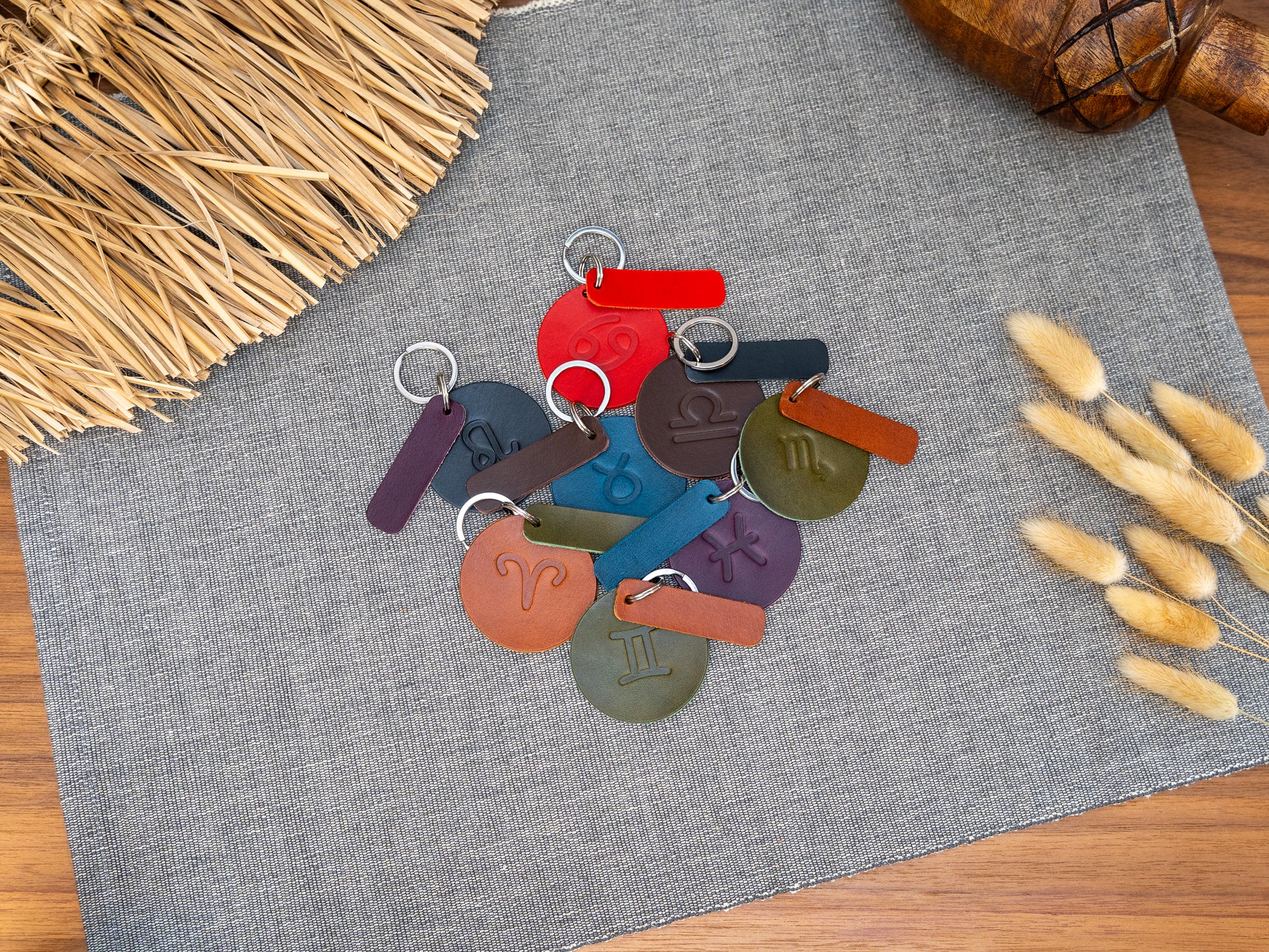 Mixture of round keyrings debossed with various zodiac signs. Keyrings also have a rectangular tab that can be personalised in black, tan, olive green, purple, red, navy blue and dark brown. Can be stamped with custom logos such as car logos, company logos. Available in several colours with stainless steel or brass hardware.