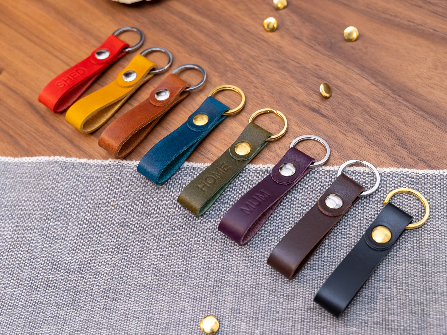 Slim Italian leather loop keyrings/keychains in multiple colours including black, brown, purple, olive green, navy blue, tan, yellow and red. Personalised with up to 6 letter debossed into the leather. Stainless steel or solid brass split ring and rivet.