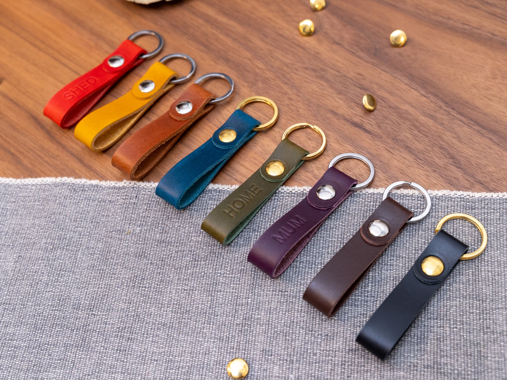 Slim Italian leather loop keyrings/keychains in multiple colours including black, brown, purple, olive green, navy blue, tan, yellow and red. Personalised with up to 6 letter debossed into the leather. Stainless steel or solid brass split ring and rivet.