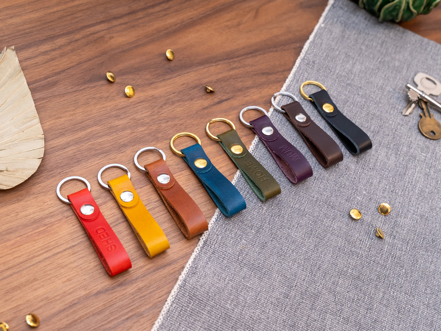 Slim Italian leather loop keyrings/keychains in multiple colours including black, brown, purple, olive green, navy blue, tan, yellow and red. Personalised with up to 6 letter debossed into the leather. Stainless steel or solid brass split ring and rivet.