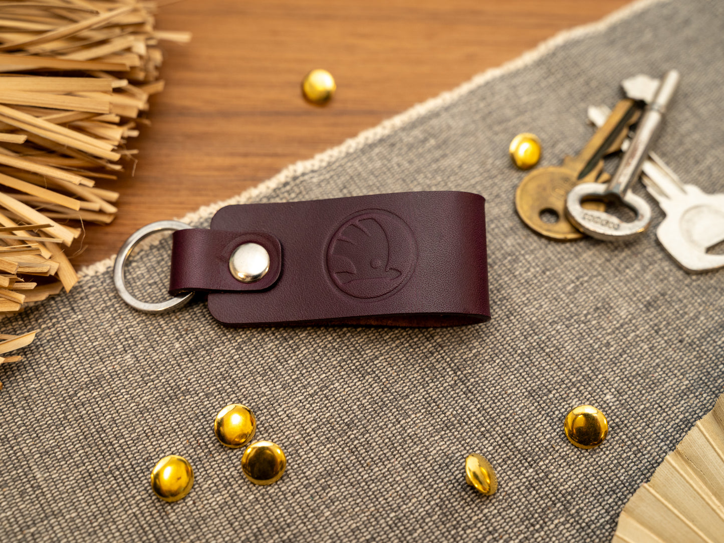 Keyring with a folded design in purple. The keychain has been embossed with the Skoda car logo. Stainless steel split ring and rivet.