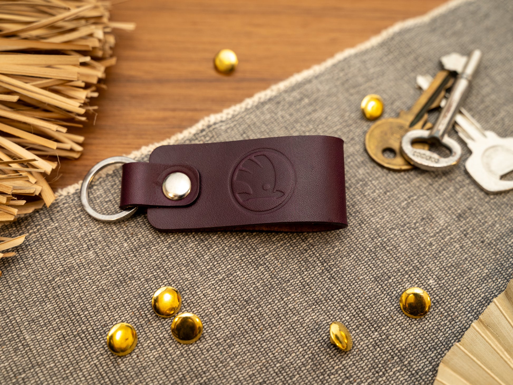 Keyring with a folded design in purple. The keychain has been embossed with the Skoda car logo. Stainless steel split ring and rivet.