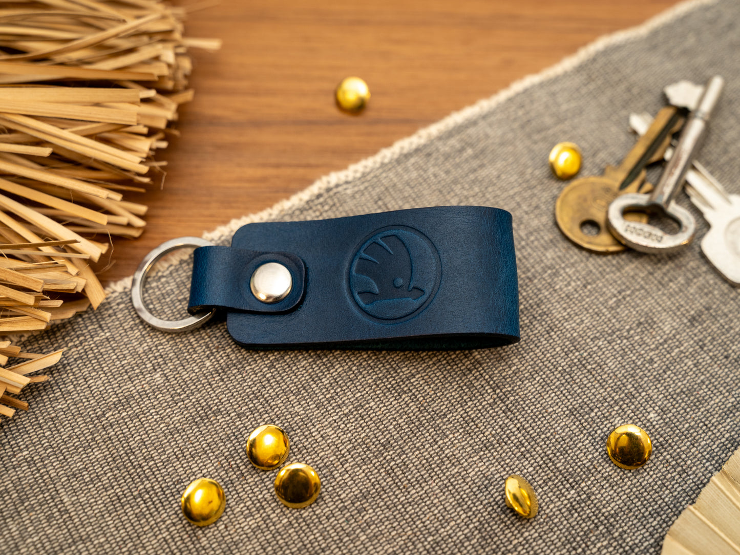 Keyring/keychain with a folded design in navy blue. The keychain has been embossed with the Skoda car logo. Stainless steel split ring and rivet.