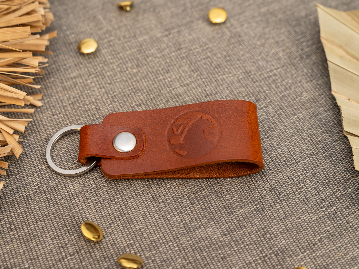 Folded tan leather keyring/keychain with the Vauxhall car logo debossed on it. Made from full grain leather with stainless steel split ring and rivet.