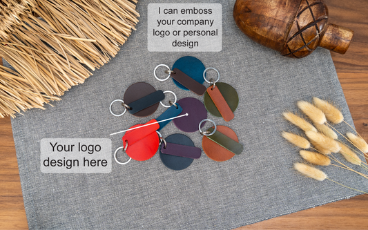Mixture of round blank keyrings with rectangular tab that can be personalised in black, tan, olive green, purple, red, navy blue and dark brown. Can be stamped with custom logos such as car logos, company logos. Available in several colours with stainless steel or brass hardware.