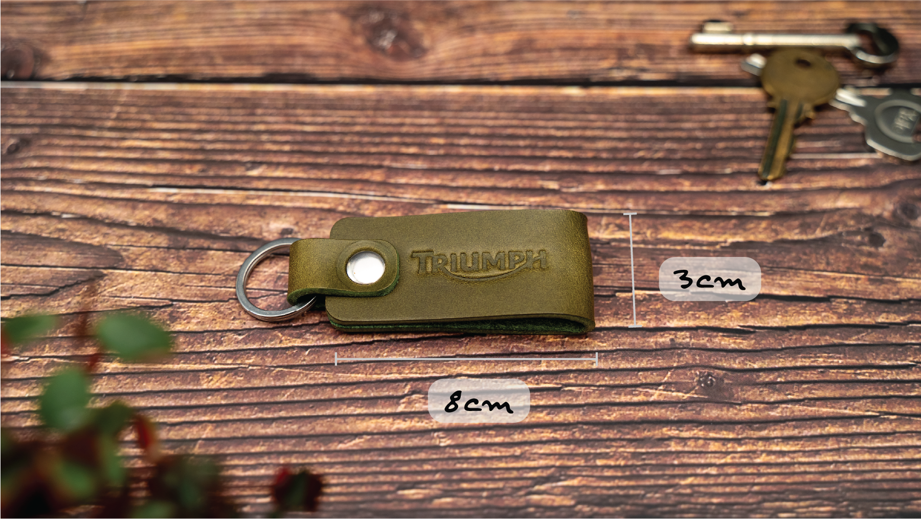 Folded olive green keyring/keychain embossed with the Triumph motorbike logo. Stainless steel split ring and rivet. Dimensions 8cm by 3cm wide