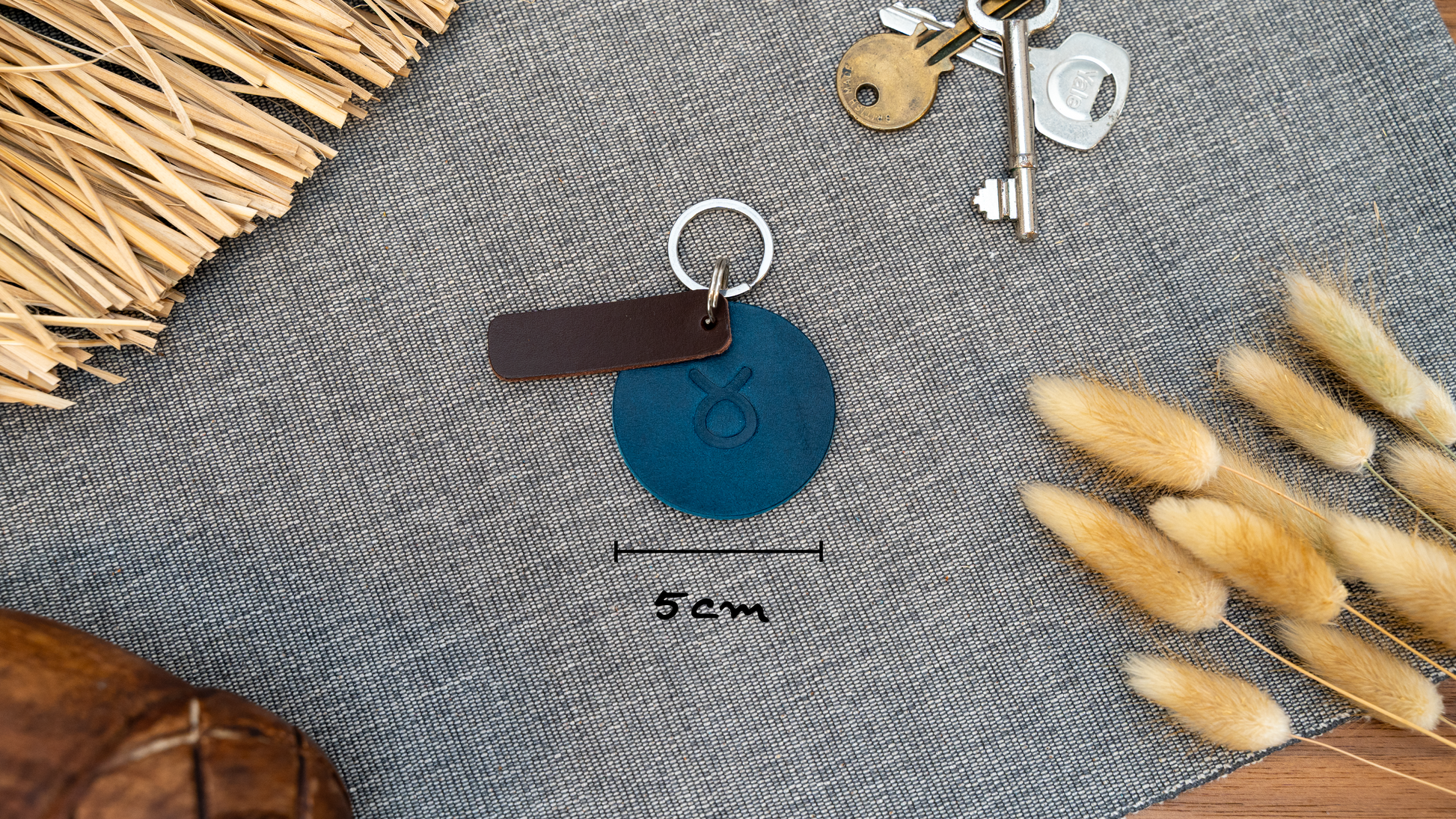 Round navy blue keyring/keychain. Stainless steel split rings. Dimensions 5cm diameter.